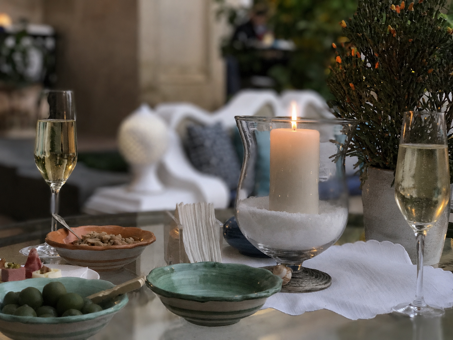 A long table set for lunch beneath an ancient olive tree at an Andalusian vineyard estate
